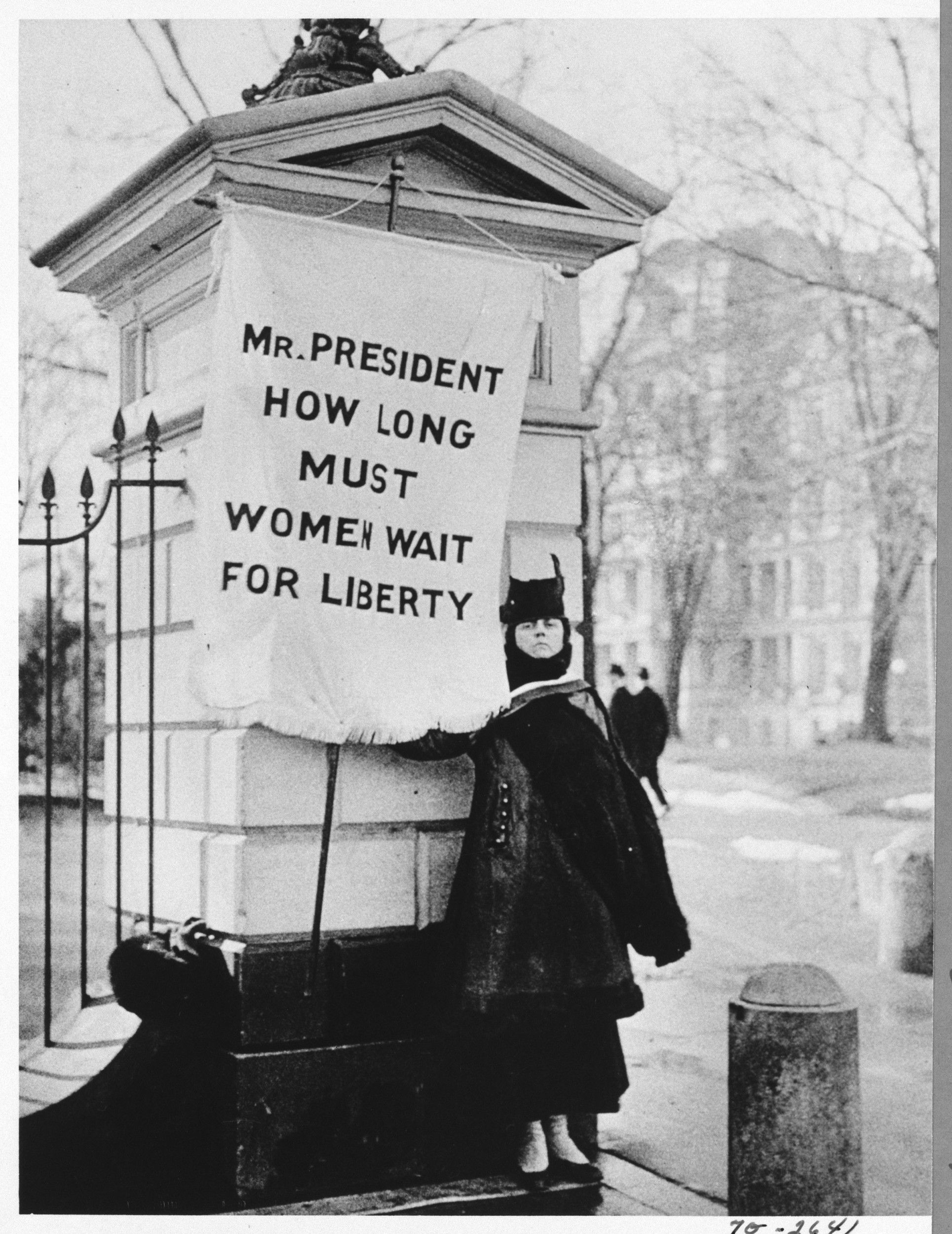 Woman holding right to vote flag, 1917
