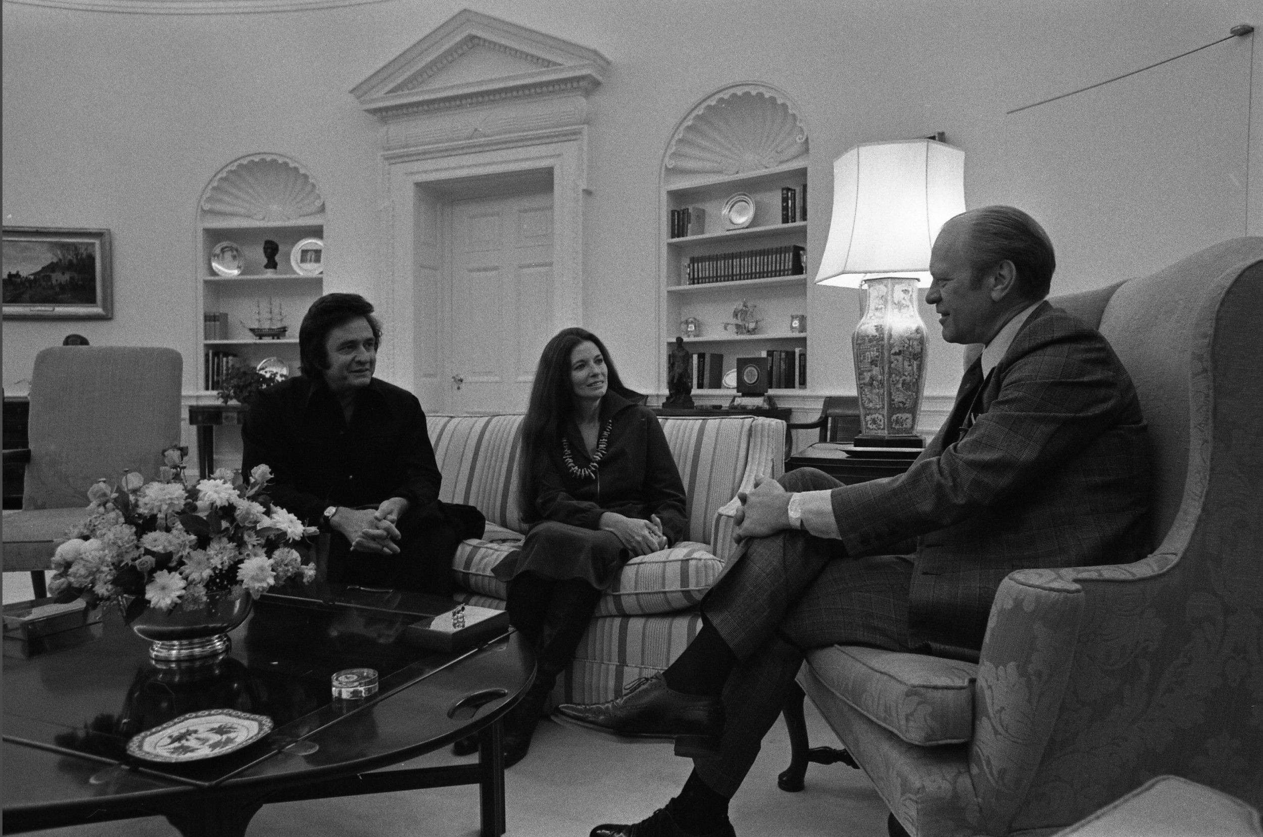 President Gerald R. Ford meets with Country Western singers Johnny Cash and June Carter Cash in the Oval Office of the White House. November 21, 1975. - History By Mail