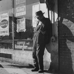 Unemployed, Destitute Man Leaning Against Vacant Store: Photo by Dorothea Lange