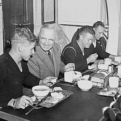 President Harry S. Truman at lunch with members of the crew of the U. S. S. Augusta, the ship that is carrying him to the Potsdam Conference in Germany. Seated with him are: Albert L. Rice, Independen