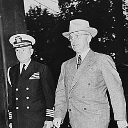 President Harry S. Truman enters Cecilienhof Palace to attend one of the meetings of the Potsdam Conference. L to R: Captain James K. Vardaman, President Truman, Secretary of State James Byrnes (backg