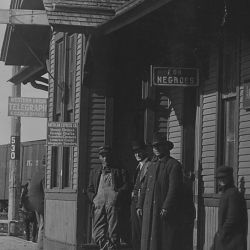 Men on railroad station platform. Hastings, Oklahoma