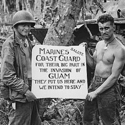 The U.S. Marines salute the U.S. Coast Guard after Battle of Guam