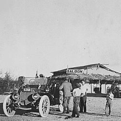 Townspeople of Ehrenburg, Ariz. Terr., greet a stranger in an automobile on his pioneer cross country tour. Saloon in background