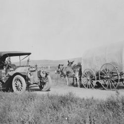 Covered wagon with jackrabbit mules encounters an automobile on the trail near Big Springs, Nebr. By A. L. Westgard