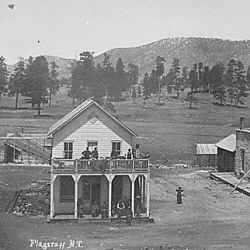 Flagstaff, Ariz. Terr. Street view of post office, other buildings, and people, with mountains in background, ca. 1899. By G. Ben Wittick