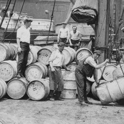 Stevedores on a New York Dock Loading Barrels of Corn Syrup onto a Barge on the Hudson River, 