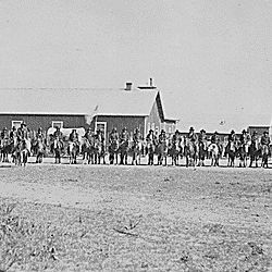 Sioux Indian police lined up on horseback in front of Pine Ridge Agency buildings, Dakota Territory