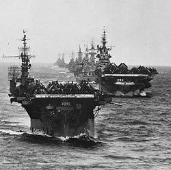 Task Group 38.3 in line as they enter Ulithi anchorage after strikes against the Japanese in the Philippines. USS Langley, Ticonderoga, Washington, North Carolina, South Dakota, Santa Fe, Biloxi, Mobi