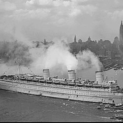The famous British liner, QUEEN MARY, arrives in New York Harbor, June 20, 1945, with thousands of U.S. troops from European battles.