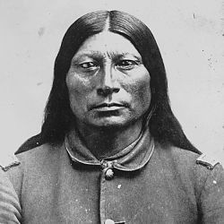Sharp Nose (Ta-qua-wi), a Northern Arapaho chief; bust-length, full-face, wearing U.S. Army captain