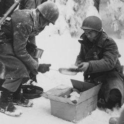 Chow is served to American Infantrymen on their way to La Roche, Belgium. 347th Infantry Regiment