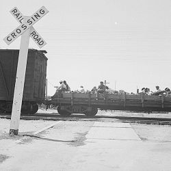 Between Bakersfield and Fresno, California. On the Freights. A typical hobo cargo riding on a flat car. Twelve are shown in this negative; the car held about fifteen of all types and ages