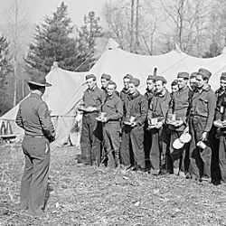 Sgt. Burke, of the U.S. Army, talking to a group of boys just arrived from New York as replacements for CCC Camp, TVA #22, near Esco, Tennessee