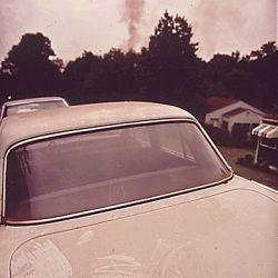 Smoke from the Neighboring Plant Settles on Everything.  The Mixture of Rain, Water and Ferrous Oxide in the Smoke Produces Sulphuric Acid Which Eats Away Automobile Finis