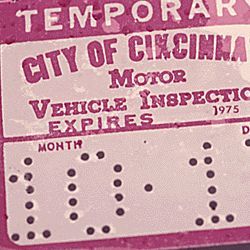 Temporary 30-day sticker attached to the windshield of a young woman’s car which had failed testing at an auto emission inspection station in downtown Cincinnati, Ohio.
