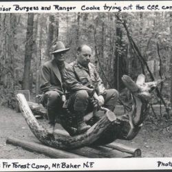 Supervisor Burgess and Ranger Cooke Trying Out the Civilian Conservation Corps Constructed Hobby Horse, Douglas Fir Forest Camp, Mt. Baker National Forest