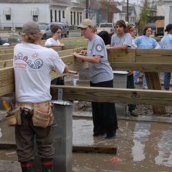 Americorps Volunteers place a floor joist on a Habitat for Humanity home after Hurricane Katrina