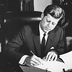 Photograph of President John F. Kennedy Signing the Proclamation for the Interdiction of the Delivery of Offensive Weapons to Cuba