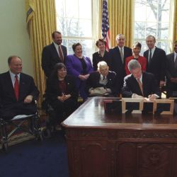 Photograph of President William Jefferson Clinton Signing Executive Order 13078, Increasing Employment of Adults with Disabilities, in the Oval Office