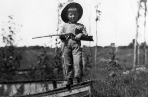 Young Ernest Hemingway holds a gun