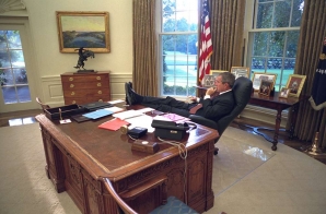 President Bush Sits at the Resolute Desk in the Oval Office