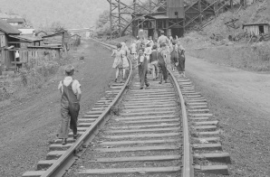 School children walk down the railroad tracks