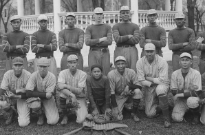 Baseball team posed in front of bandstand