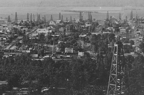 "Cleveland. The City of Oil Derricks." Panoramic view of an Oklahoma Territory town a year after the discovery of oil there