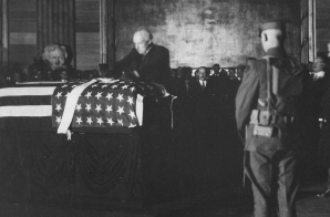 President Harding placing wreath of flowers on casket of Unknown Soldier in rotunda of the Capitol.
