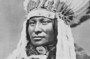 Rain-in-the-Face, a Hunkpapa Sioux; bust-length, full-face, wearing feathered headdress 