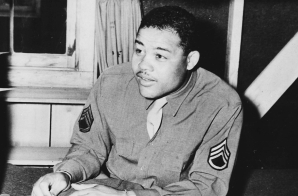 "World Heavyweight champ Joe Louis (Barrow) sews on the stripes of a technical sergeant---to which he has been promoted..."