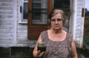 Mary Workman Holds a Jar of Undrinkable Water that Comes from Her Well