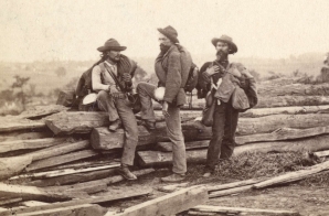 Three "Johnnie Reb" prisoners captured at Gettysburg. There were hardly two suits alike in a whole regiment; however, "a man is a man for a